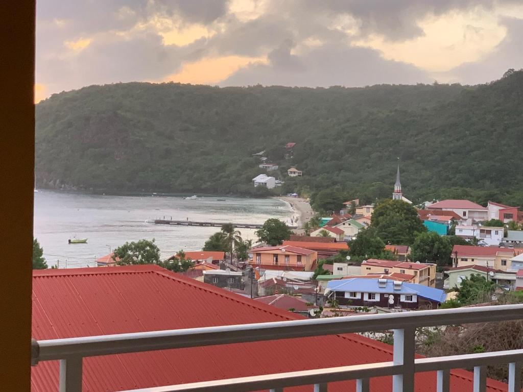 a view of a town with a river and a city at Ocean bleu 972 Marron N 3 in Les Anses-dʼArlets
