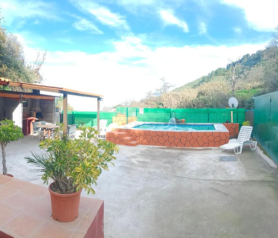 un patio con piscina, mesa y sillas en Chalet Ruta Las Lagunetas, en Vega de San Mateo