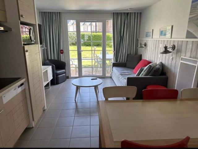 a living room with a couch and a table at Residence de la Plage Pierre et Vacances in Le Crotoy