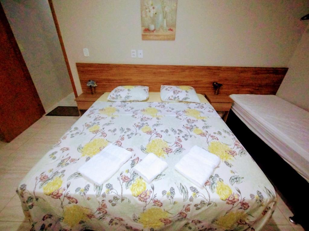 Postel nebo postele na pokoji v ubytování Pouso Oliveira Suítes