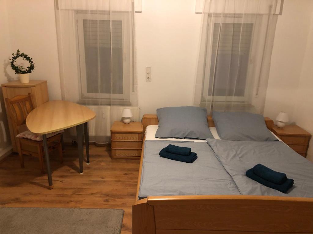 a bedroom with two beds and a table and a desk at Siegen Zentral - S von eine bis zum mehrere Schlafplätze nach Wall in Siegen