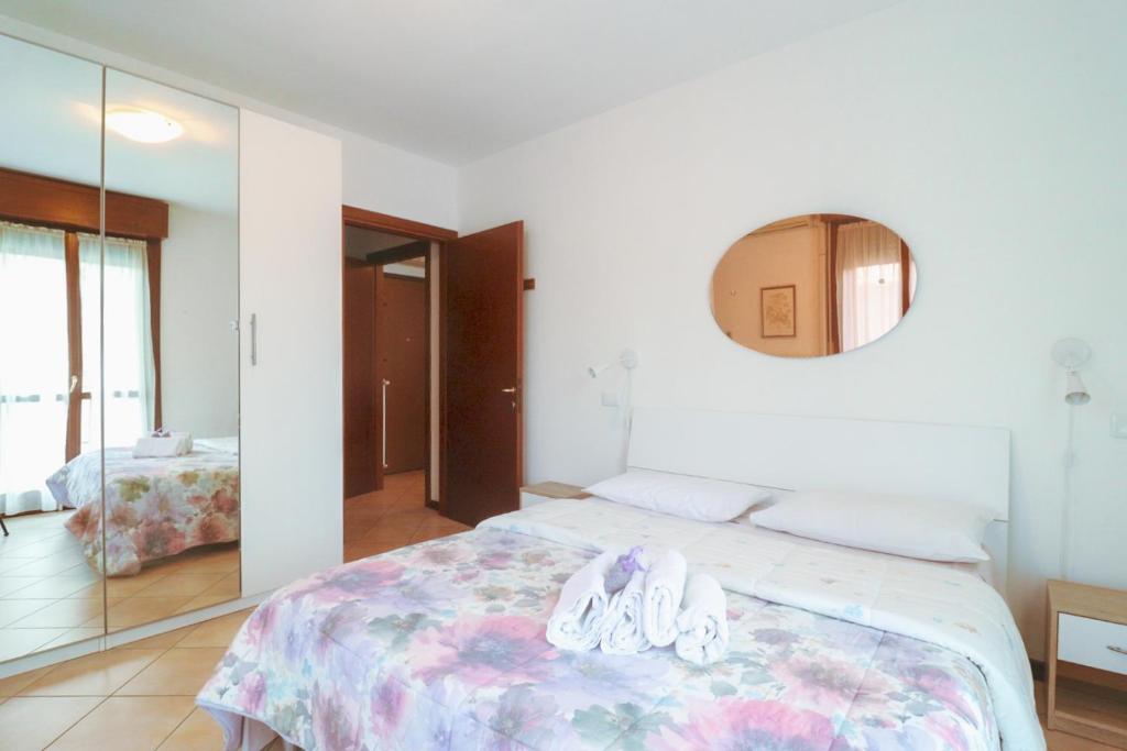 a bedroom with a large bed with a mirror at Campovolo Cozy Apartment in Reggio Emilia