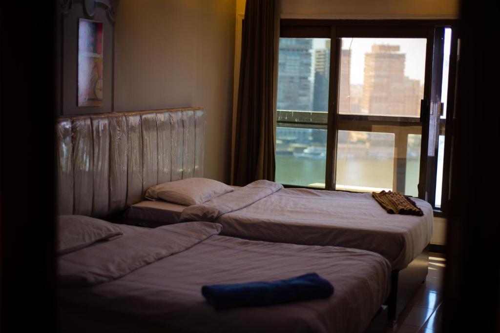 Postel nebo postele na pokoji v ubytování Jasmine Nile Sky Hotel