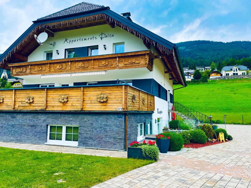 a large building with a wooden roof at Appartements-Dalila in Sankt Michael im Lungau