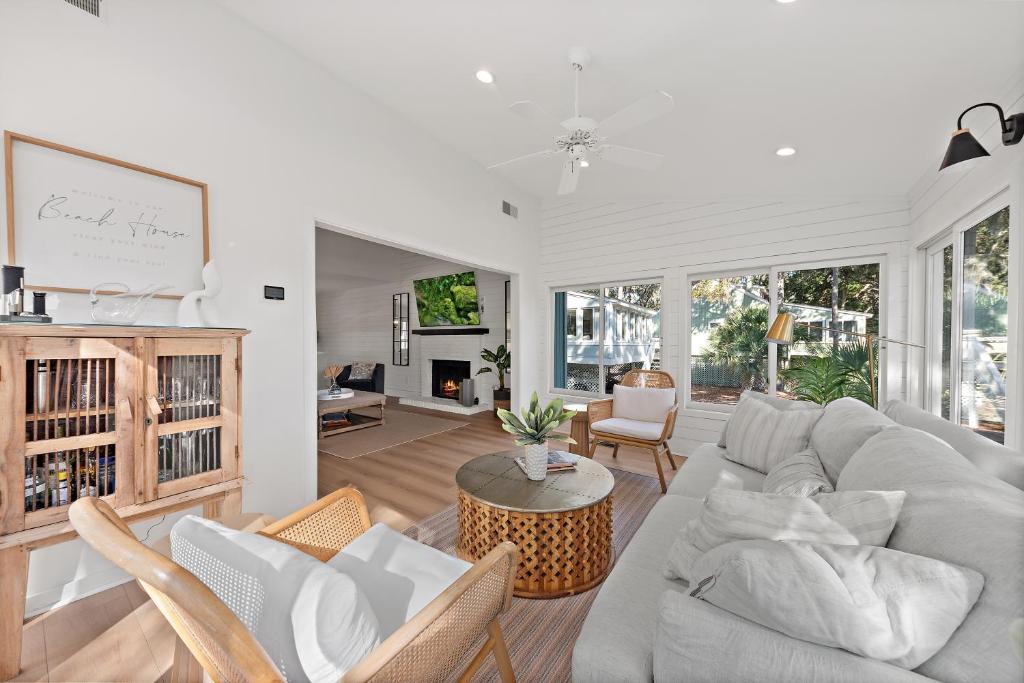 a living room with a couch and a table at 542 Tarpon Pond Cottage in Seabrook Island