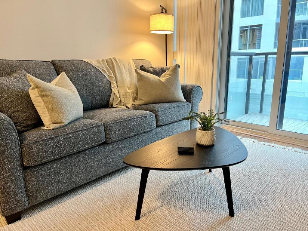 a living room with a couch and a coffee table at Cozy & charming Downtown condo! in Toronto