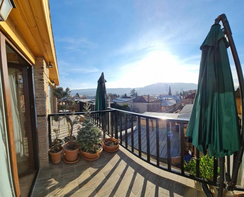 a balcony with umbrellas and potted plants at Apart10 "Capture Old Tbilisi Spirit" in Tbilisi City