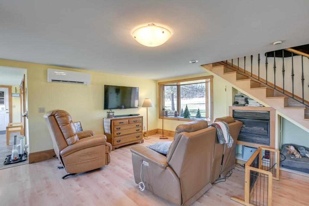 a living room with two chairs and a staircase at Quiet Bradford Retreat Near Hiking and Fishing! 