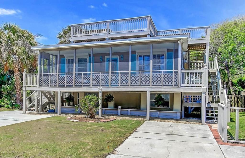 a large house with a large deck and stairs at Sandy Cheeks in Folly Beach