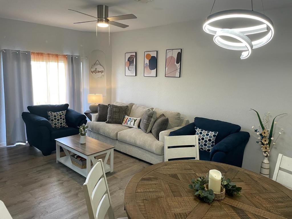 a living room with a couch and a table at Cozy Stylish Townhome in Davenport