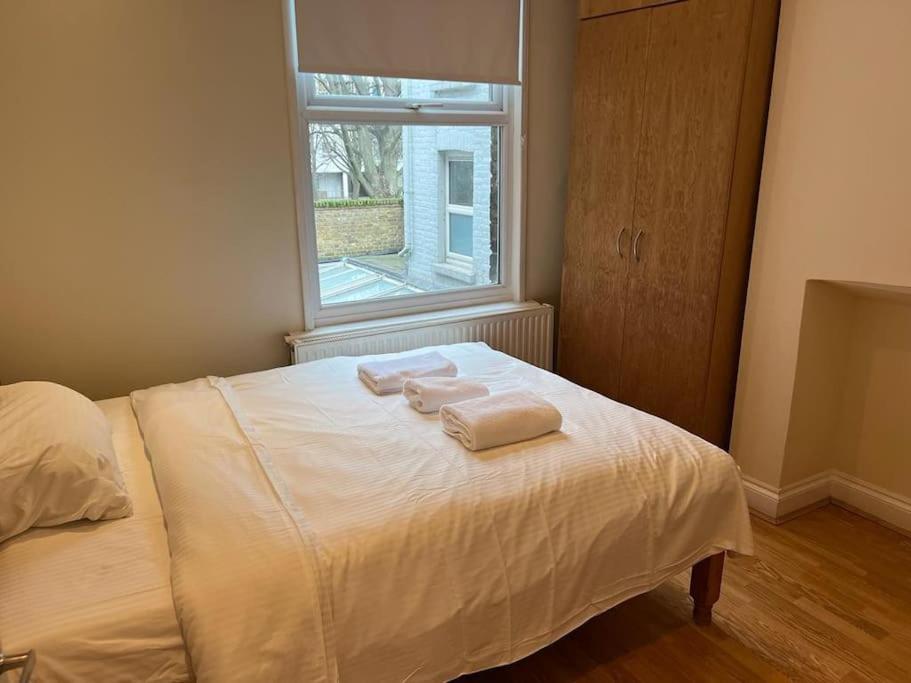 a bedroom with a bed with two towels on it at Flat in London King’s Cross in London
