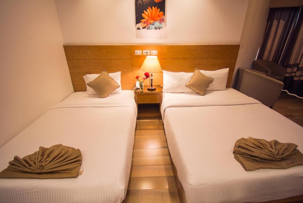 Postel nebo postele na pokoji v ubytování Nile Guardian Hotel