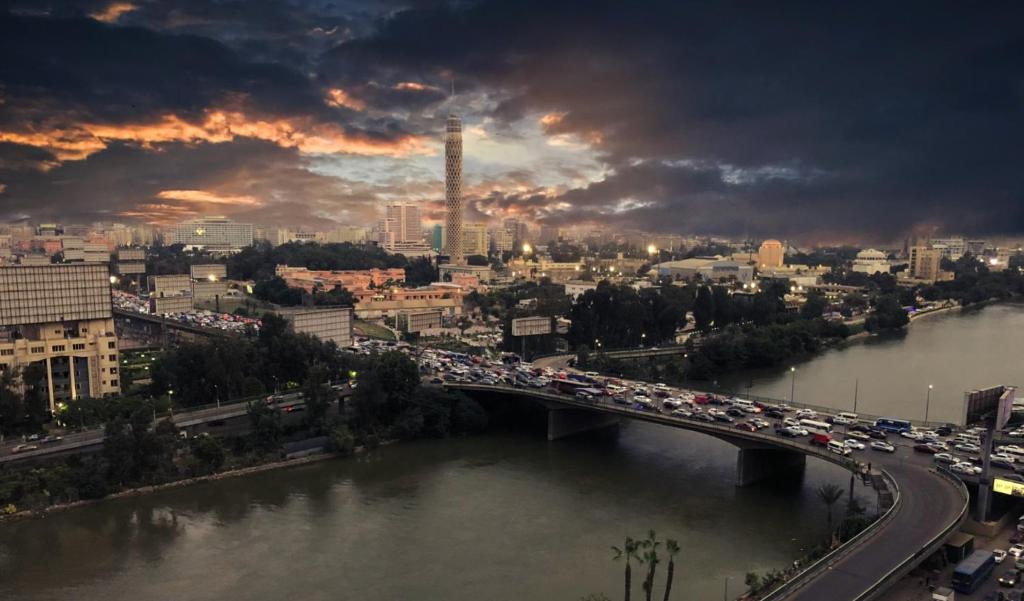 a bridge over a river with traffic on it at Nile Guardian Hotel in Cairo