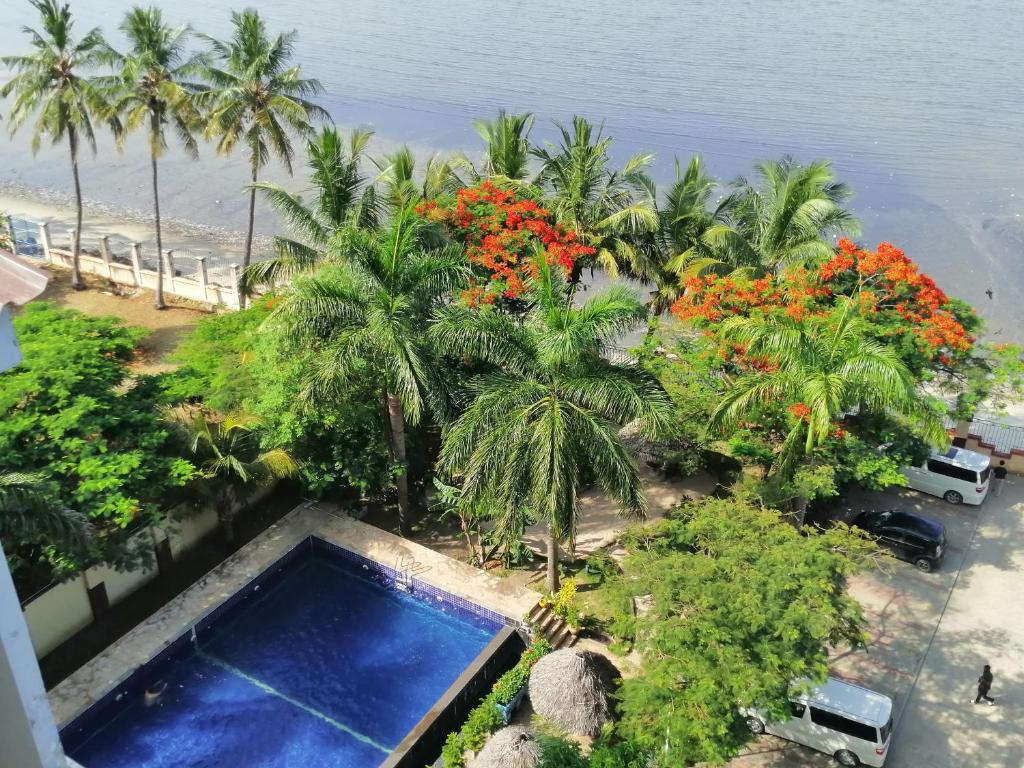 an aerial view of a resort with a swimming pool and palm trees at Arrabella Ocean View Home in Dar es Salaam