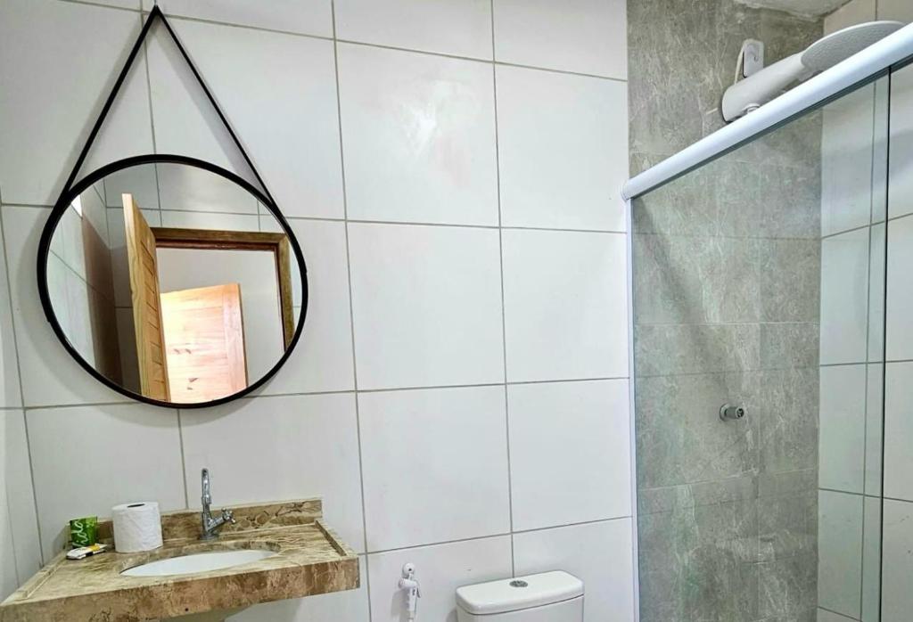 a bathroom with a mirror and a sink at Pousada Mali in Canoa Quebrada