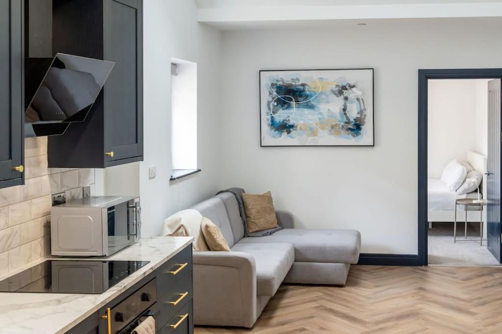 ein Wohnzimmer mit einem Sofa und einem TV in der Unterkunft Luxury in the City Centre 2 Bed by Home Host in Cardiff