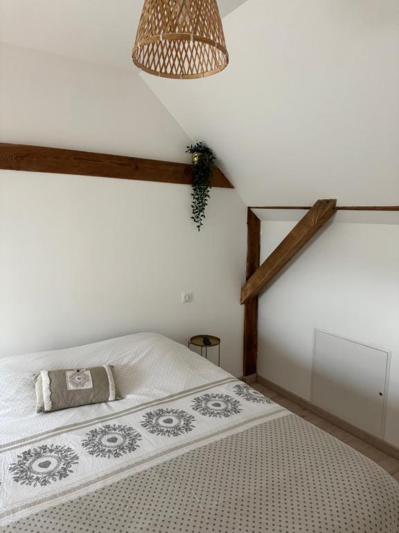 a bedroom with a white bed with a lamp at Duplex au cœur de l’Alsace in Muttersholtz