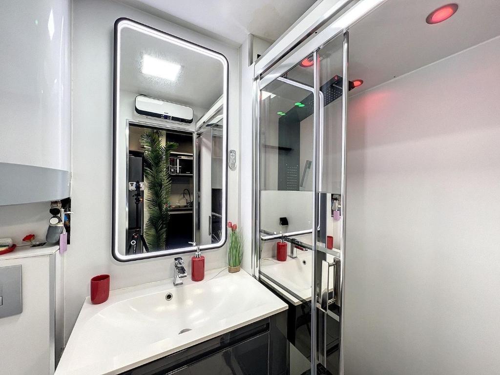 a bathroom with a sink and a mirror at 12 Phantasm in Cap d'Agde