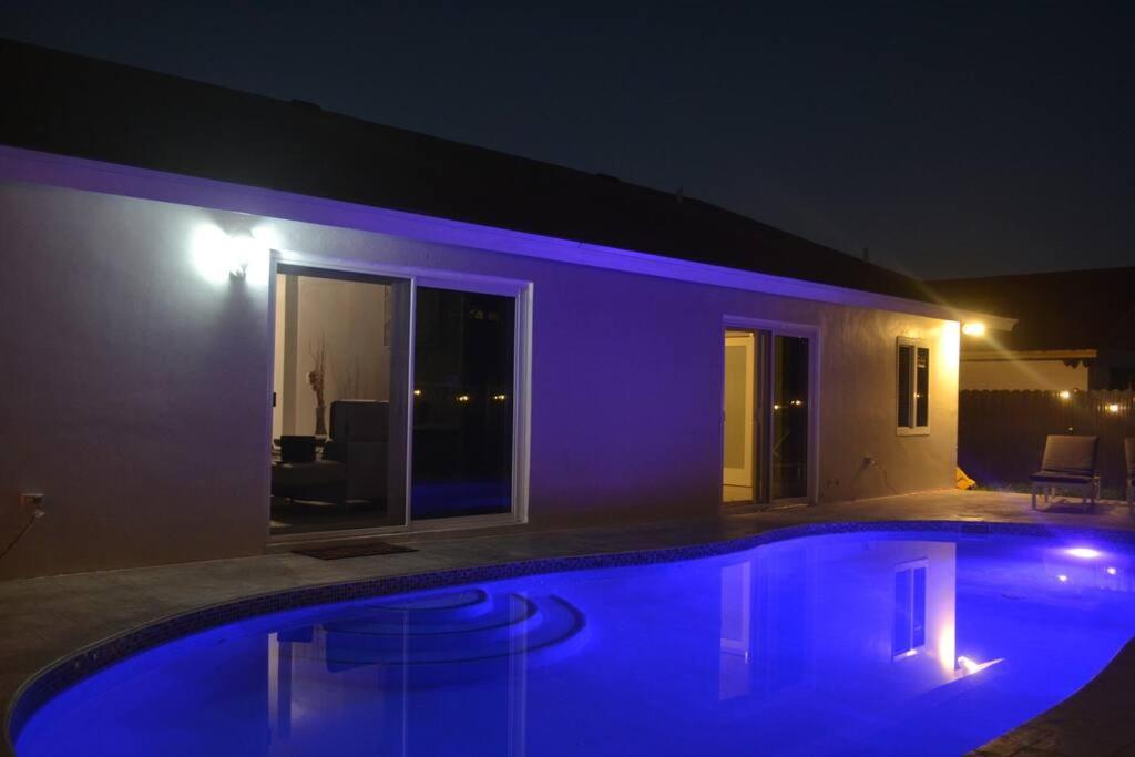 una piscina frente a una casa por la noche en Spacious 4 bedrooms, 2 bathroom house with pool, en Miramar