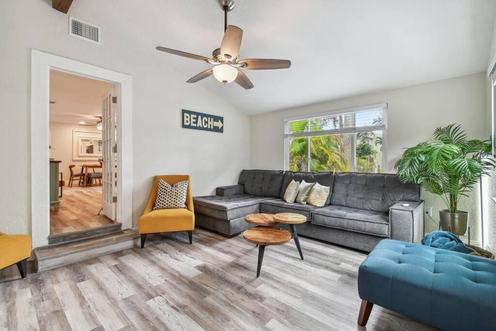 a living room with a couch and a ceiling fan at Chic & Cozy 3 Bed/2 Bath House Near Beaches in Largo