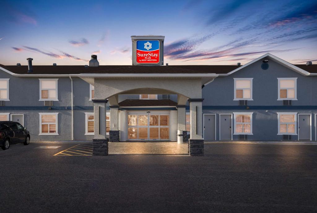 a large building with a sign on top of it at SureStay Plus by Best Western Brooks in Brooks