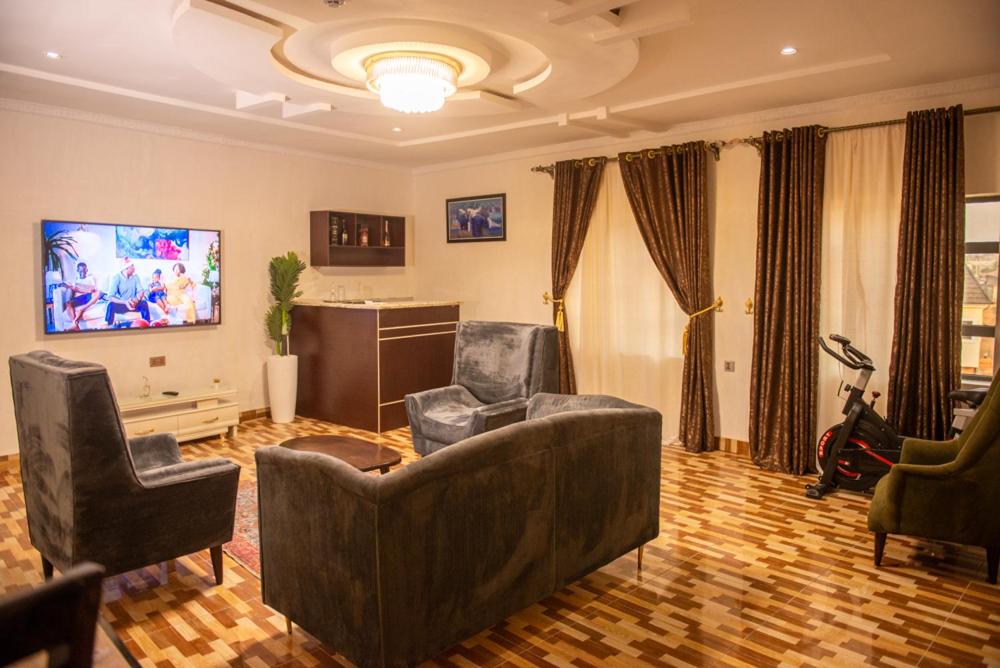 a living room with a couch and two chairs at Abada Luxury Hotel and Suites in Onitsha