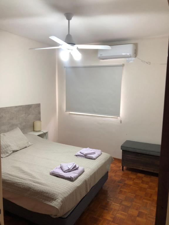 Un dormitorio con una cama con toallas moradas. en CERRO GODOY CRUZ en Mendoza