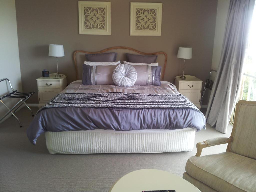 a bedroom with a large bed with purple sheets and pillows at Waterview Gardens B&B in Margate