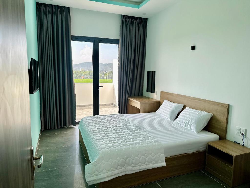 מיטה או מיטות בחדר ב-Ruby Motel Bà Rịa