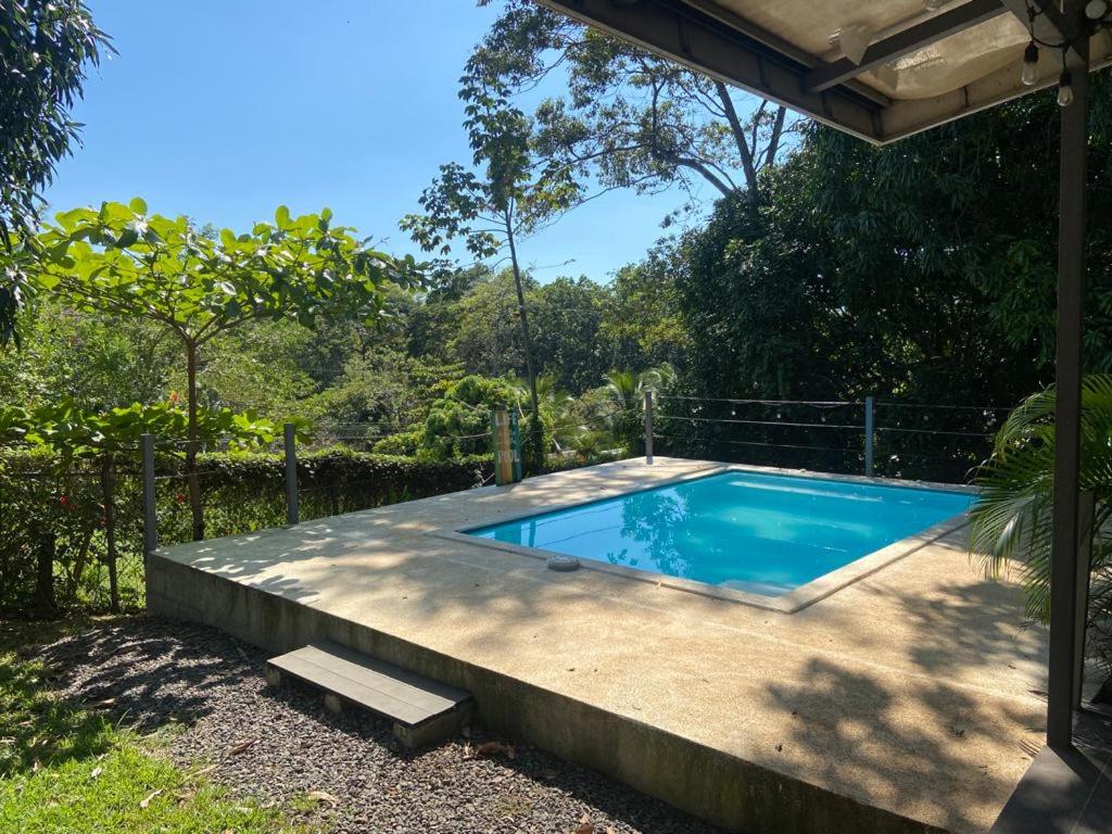a small swimming pool in a yard with a fence at Casa Mangos in Orotina