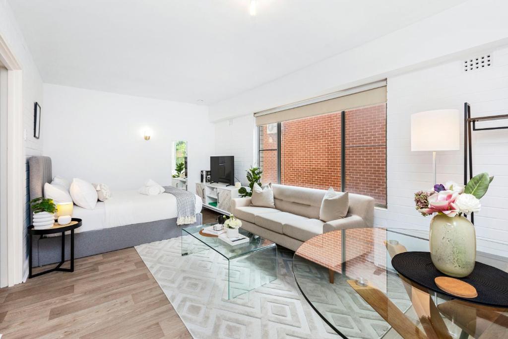 a living room with a couch and a table at Urban Chic Studio by 'the Strip' in Perth