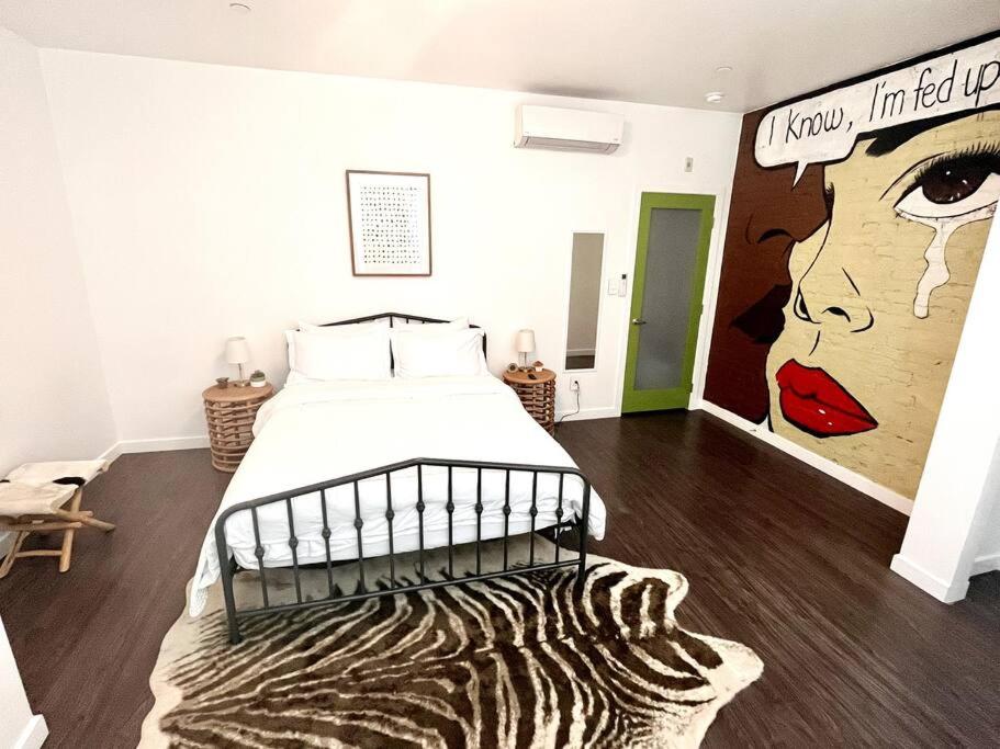 a bedroom with a bed and a mural of a woman at Beautiful 1 BR Art DECO Inspired in Philadelphia