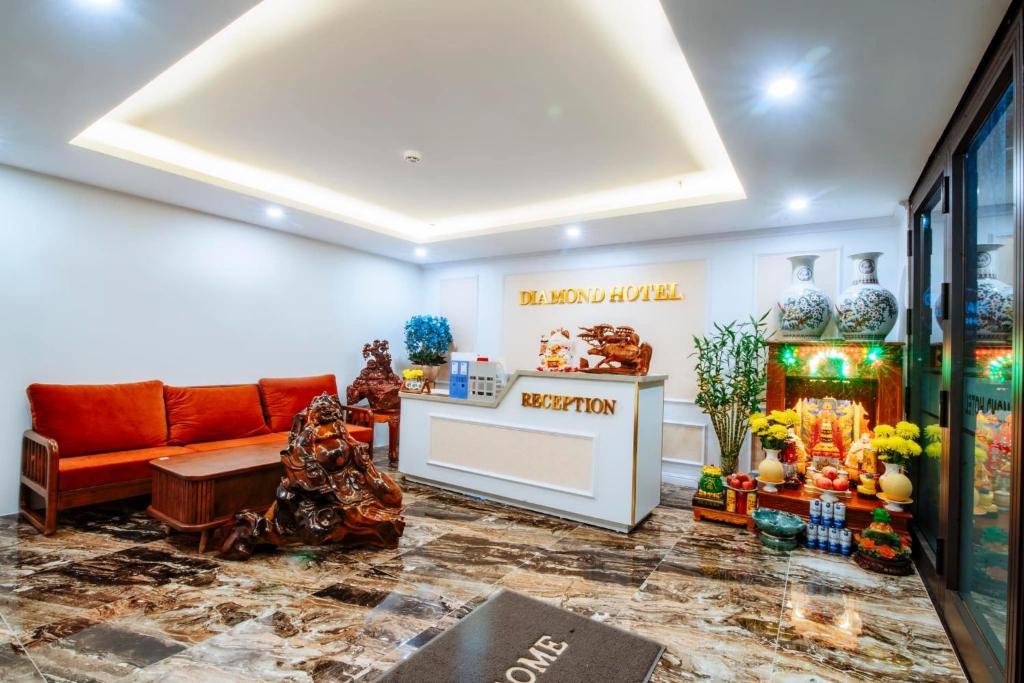 a lobby with a couch and vases on the wall at Diamond Hotel Quảng Bình in Dong Hoi