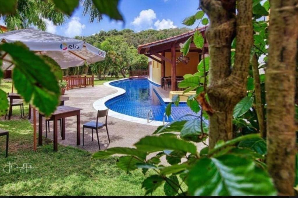 a resort with a swimming pool and a house at Pipa - Bosque da Praia Flat 14 in Pipa