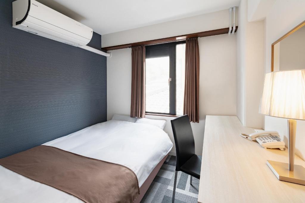 Postel nebo postele na pokoji v ubytování Auberge Amanohashidate