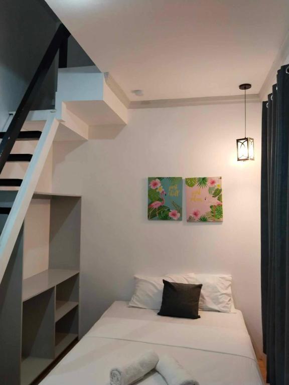 Voodi või voodid majutusasutuse Mannah Garden Staycation Place toas
