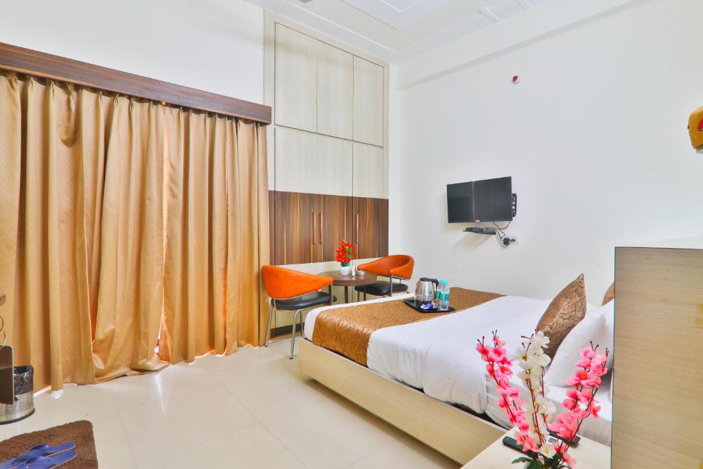 a hotel room with a bed and a desk at Gulmohar inn in Lucknow