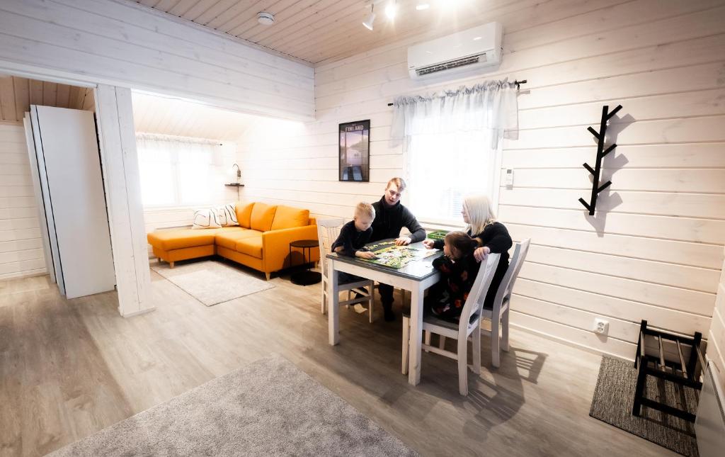a group of people sitting at a table in a room at Holiday Resort Harjun Portti in Punkaharju
