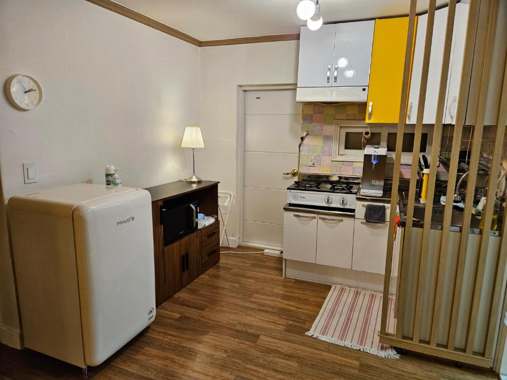 a kitchen with a refrigerator and a stove at Vivir Stay Seoul in Seoul