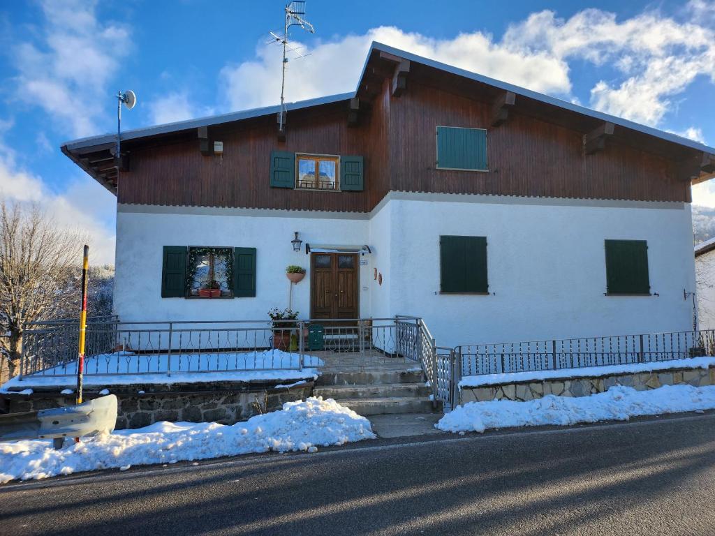 a white house with a brown and white at Appartamenti Bice Abetone in Abetone