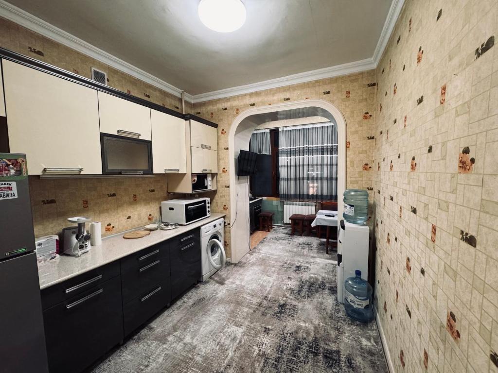 a kitchen with a washer and dryer in a room at Апартамент в городе Андижане in Andijan