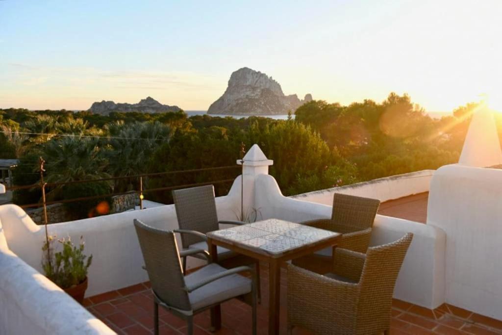 una mesa y sillas en un balcón con vistas en apartment with magnificient Es Vedra view, en Cala Vadella