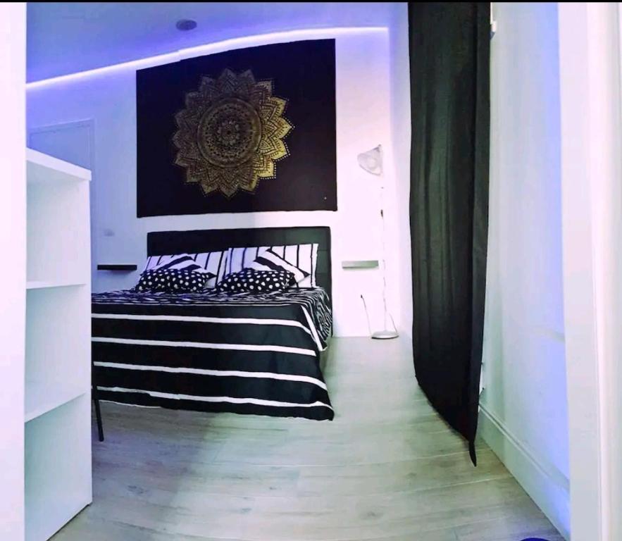 a bedroom with a bed with black and white stripes at wanderlust in Pomezia