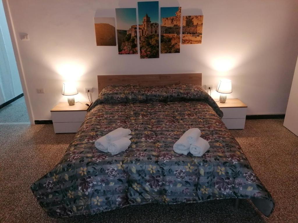 a bedroom with a bed with two white shoes on it at A casa di Vito in Matera