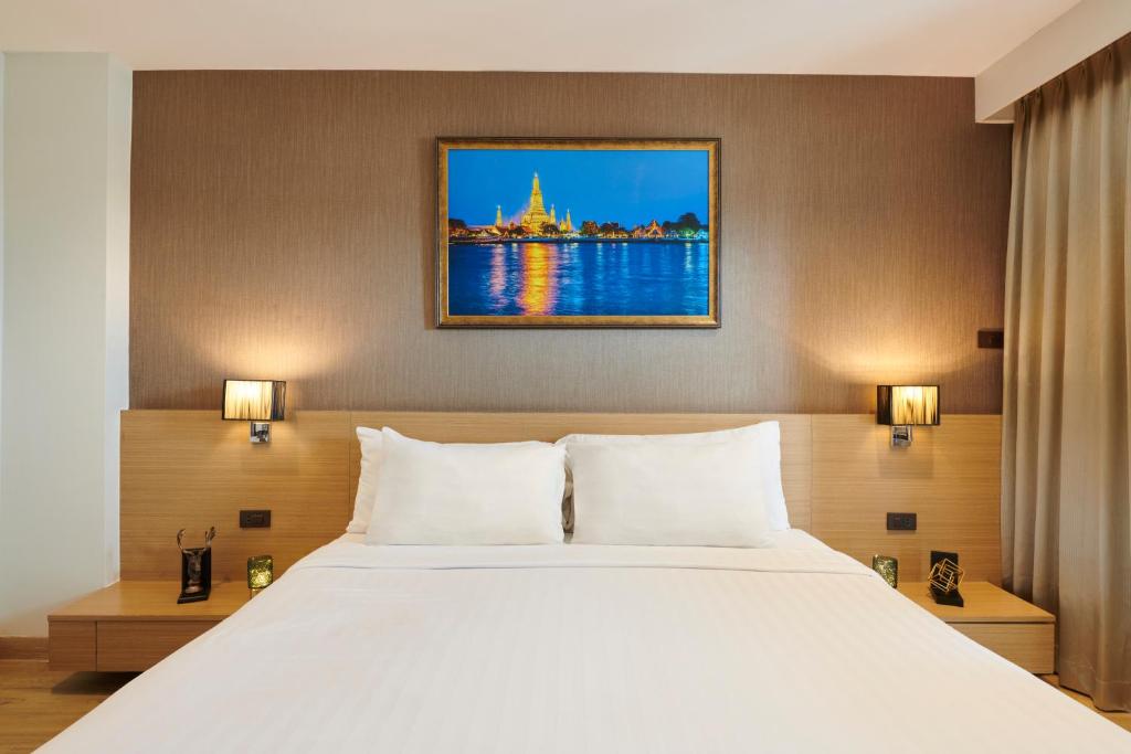Postel nebo postele na pokoji v ubytování Adelphi Pattaya