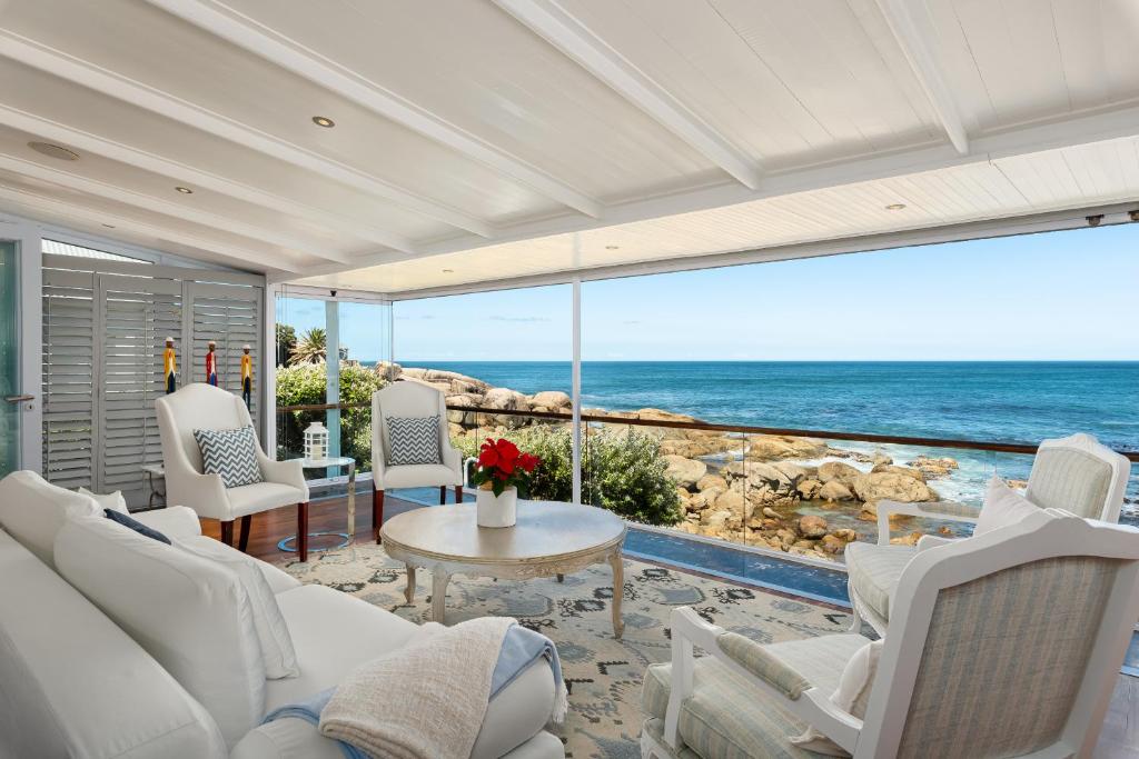 a living room with a view of the ocean at Sea Haven - Bakoven Beach Front Villa in Cape Town