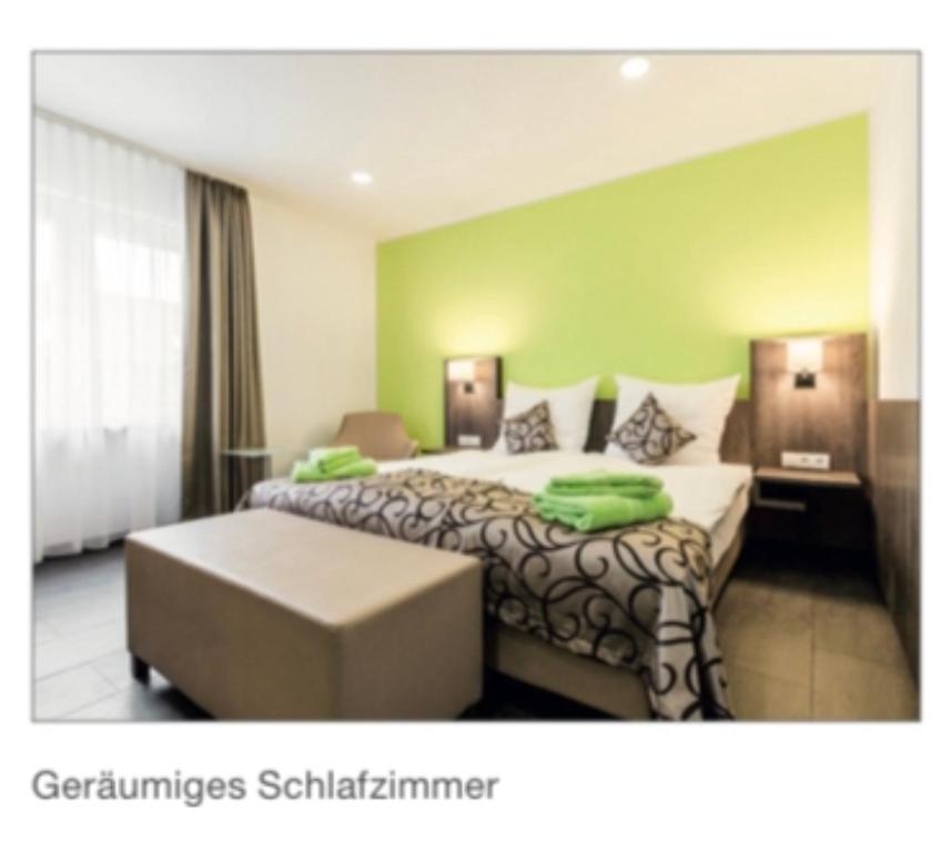a hotel room with two beds in a room at Im Tal 2 Apartment WH2 OG in Bergheim