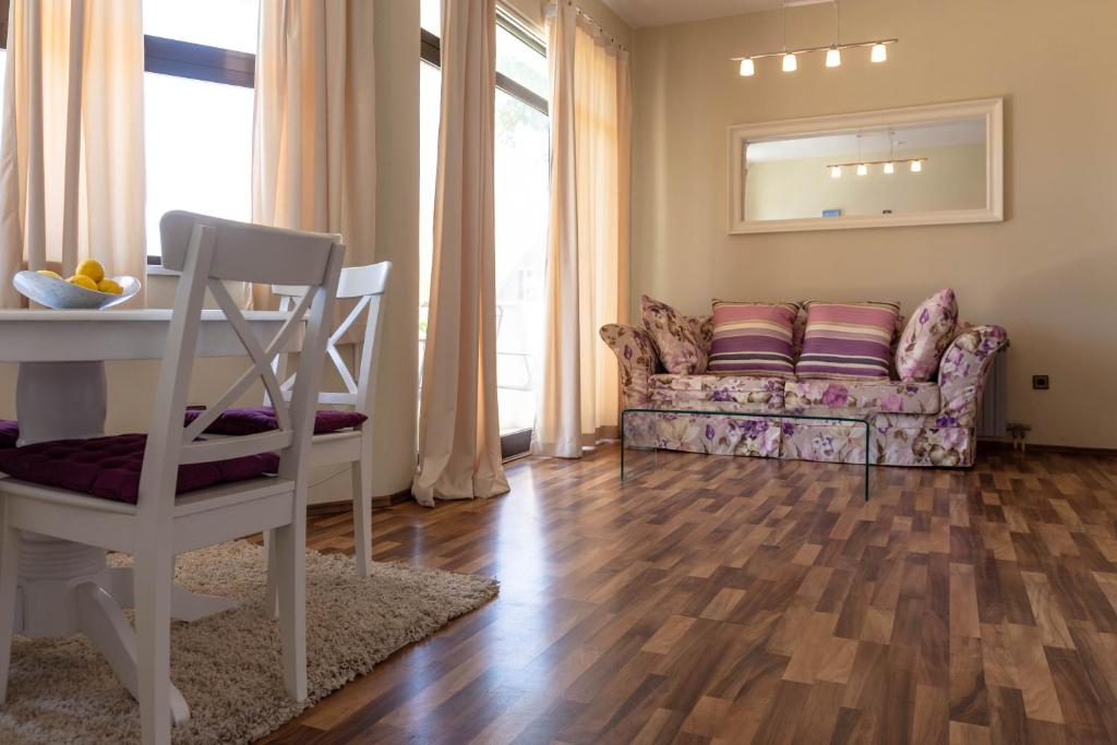 a living room with a couch and a table at By the sea West Apartments in Kaštela