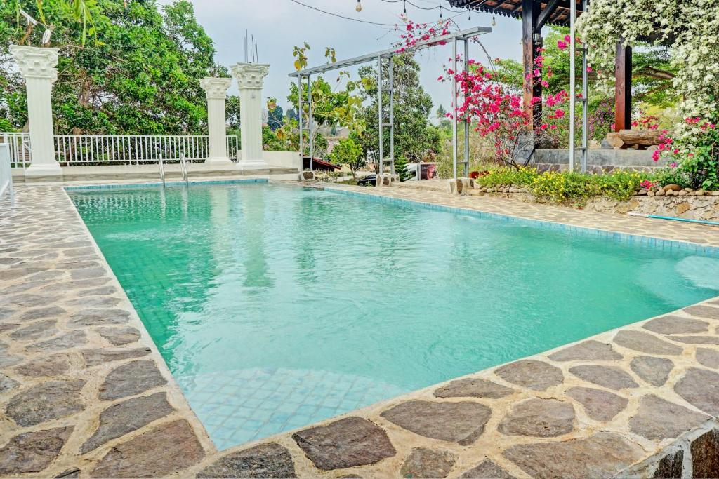 a swimming pool with turquoise water at Capital O 93345 The Saka Guest House Syariah in Bandar Lampung