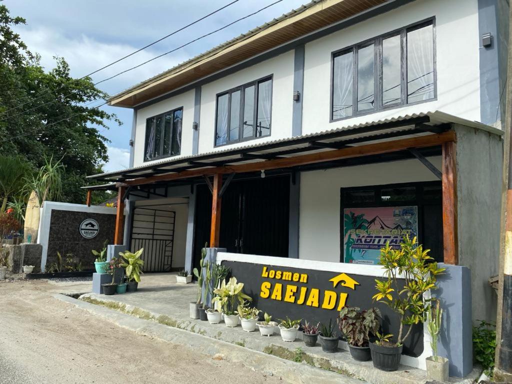 a building with a sign that reads main seafood at Krui Saejadi Surf and Stay in Krui